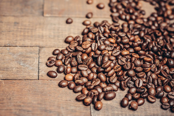 coffee beans scattered on a wooden background