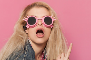 Barbie pop girl wearing odd sunglasses and making middle finger