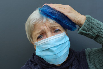 senior woman with a strong headache and influenza