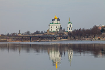 Pskov Kremlin fortress. Cathedral and main bridge reflection in the river