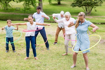 Multi-generation family playing with hula hoop © WavebreakMediaMicro