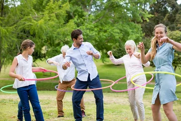 Foto op Plexiglas Multi-generation family playing with hula hoop © WavebreakMediaMicro