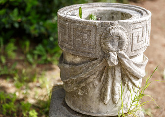 Pretty stone flowerpot in a garden