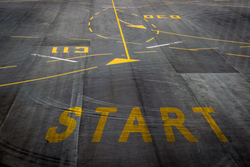 The start words on the surface of the airport runway background for business concept.