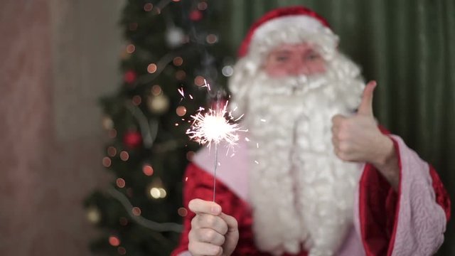 Closeup portrait of Santa Claus, sparkler in hand new year, christmas