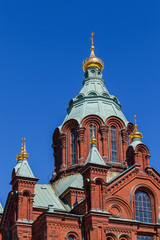 Fototapeta na wymiar Uspenski Cathedral On Hill At Summer Sunny Day. Red Church - Tourist destination In Finnish Capital