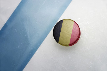 old hockey puck with the national flag of belgium