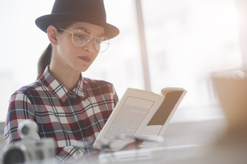 hipster style woman is reading a book
