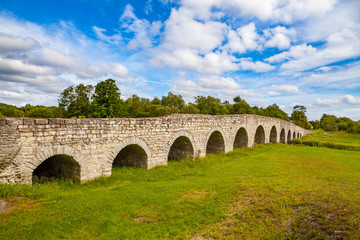 Fototapeta na wymiar View of the Historic Old Stone Bridge over the river on Estonian island