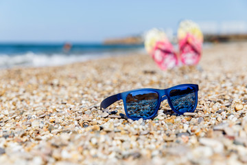 Sun glasses and beach shoes