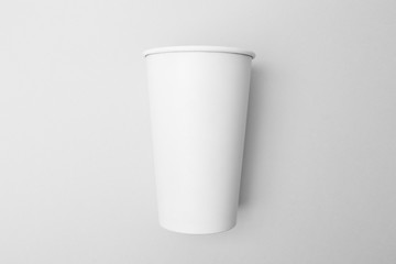 Blank white paper cup on the grey background