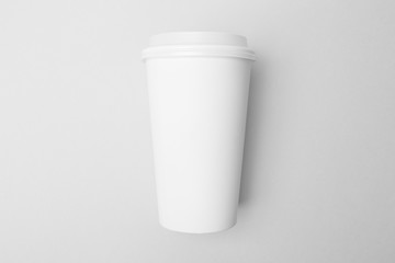 Blank white paper cup on the grey background
