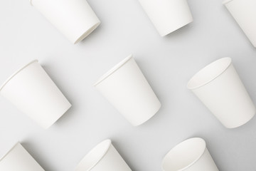 Blank white paper cups on the gray background