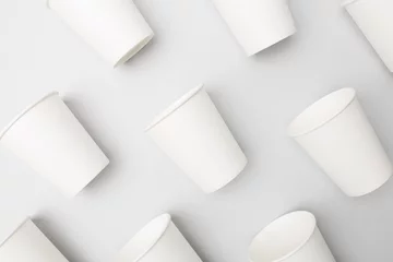 Foto op Aluminium Blank white paper cups on the gray background © SQS