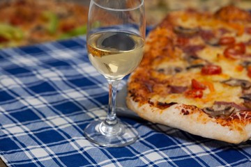 Delicious pizza with a glass of wine