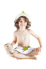 Cute curly little boy sitting with a wooden mug in hand, cross-legged clothing sauna. White background. © kravik93