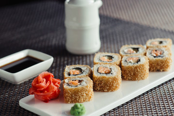 hot sushi on a white plate with chopsticks © maxfotoadobe