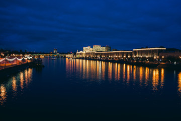 Obraz premium Moscow, Russia. Night cityscape with bridge and Moscow river. Color bars on the headlights. Slow shutter speed