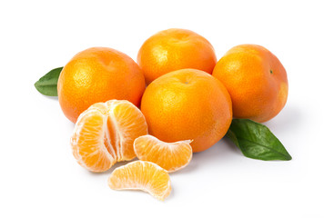 Ripe mandarin with leaves close-up on a white background.
