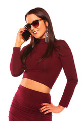 young woman in a burgundy dress and sunglasses talking in your m