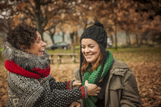 Women conversating in a park in autumn