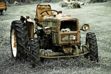 Rusty tractor abandoned in a field