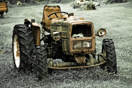 Rusty tractor abandoned in a field
