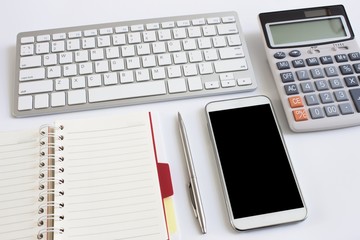 office table with notebook, computer keyboard and smartphone. copy space