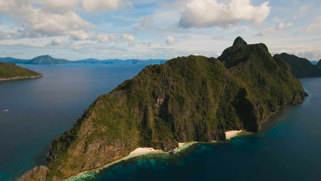 Tropical bay in El Nido.Aerial view: bay and the tropical islands. Tropical landscape.Sky and mountains rocks. Aerial:mountains Blue lagoon in the ocean. Aerial video.Seascape: sky, mountains, ocean