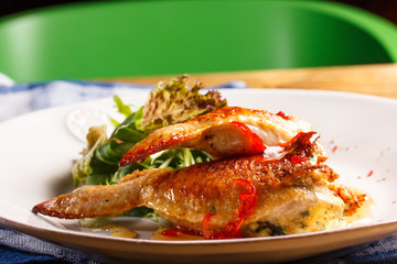 Fried chicken with chilli and lettuce on the plate.