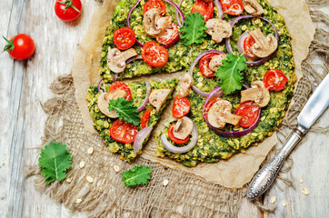 Kale oats pizza crust with tomato, red onion and mushrooms