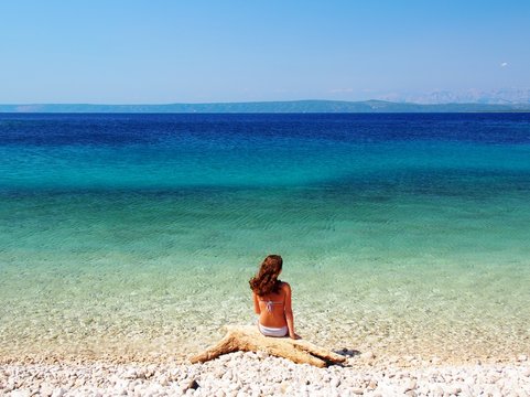 Woman sitting on the beautiful beach