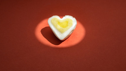 Egg heart on red. Romantic background concept
