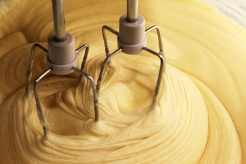 Electric hand mixer with the dough for the pie
