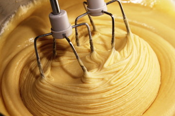 Electric hand mixer with the dough for the pie
