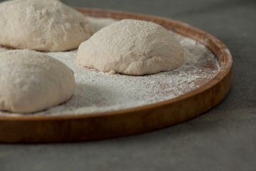Pizza dough and flour on rolling board