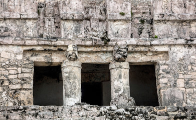 Fototapeta premium Details of the facade of the ancient Mayan Pyramid El Castillo (The Castle) in the Tulum Archaeological Zone, Quintana Roo, Mexico