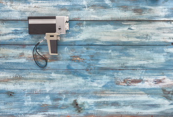 Video and photo camera on a blue old vintage blue background. Photographed in retro style