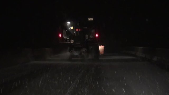 Snow Plow at Night on Highway during Snowstorm