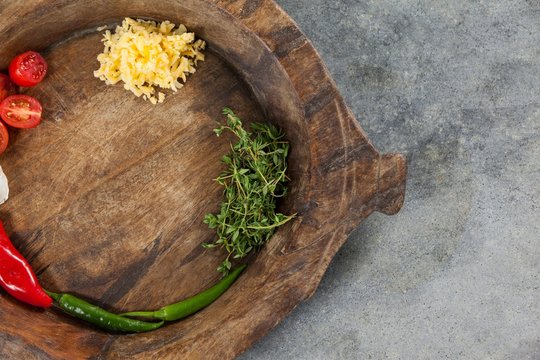 Spices and vegetable in wooden bowl
