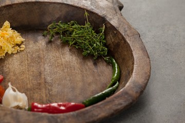Spices and vegetable in wooden bowl