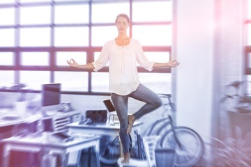 Female business executive performing yoga