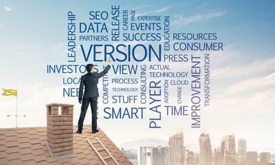 Young businessman standing on house roof and writing leadership 