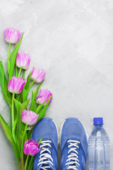 Spring flatlay sports composition with blue sneakers and purple