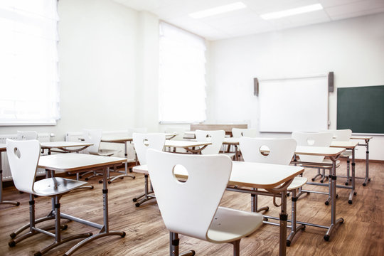 Empty Classroom With Chairs And Desks