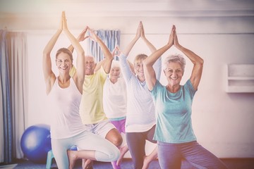 Instructor performing yoga with seniors