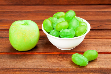 apple and grape in a drinking bowl.
