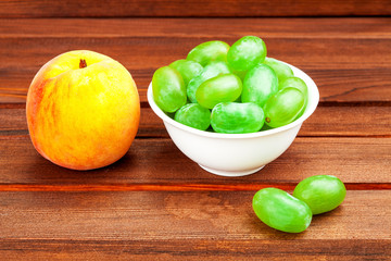 peach and  grape in a drinking bowl.