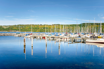 Fototapeta na wymiar Sailing Boats in Harbour on a Sunny Autumn Day. Seneca Lake, Upstate New York