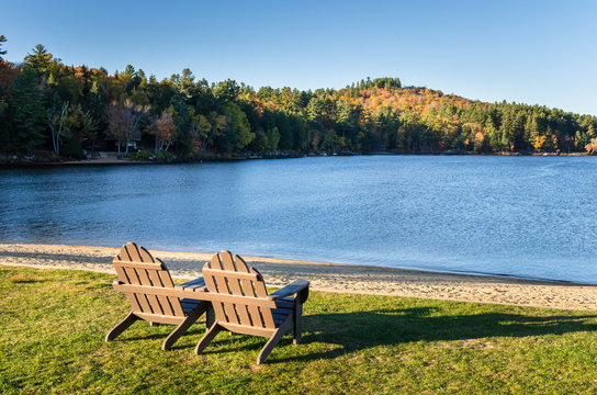 Adirondack Chairs on the Shore of a Beautiful Lake at Sunset